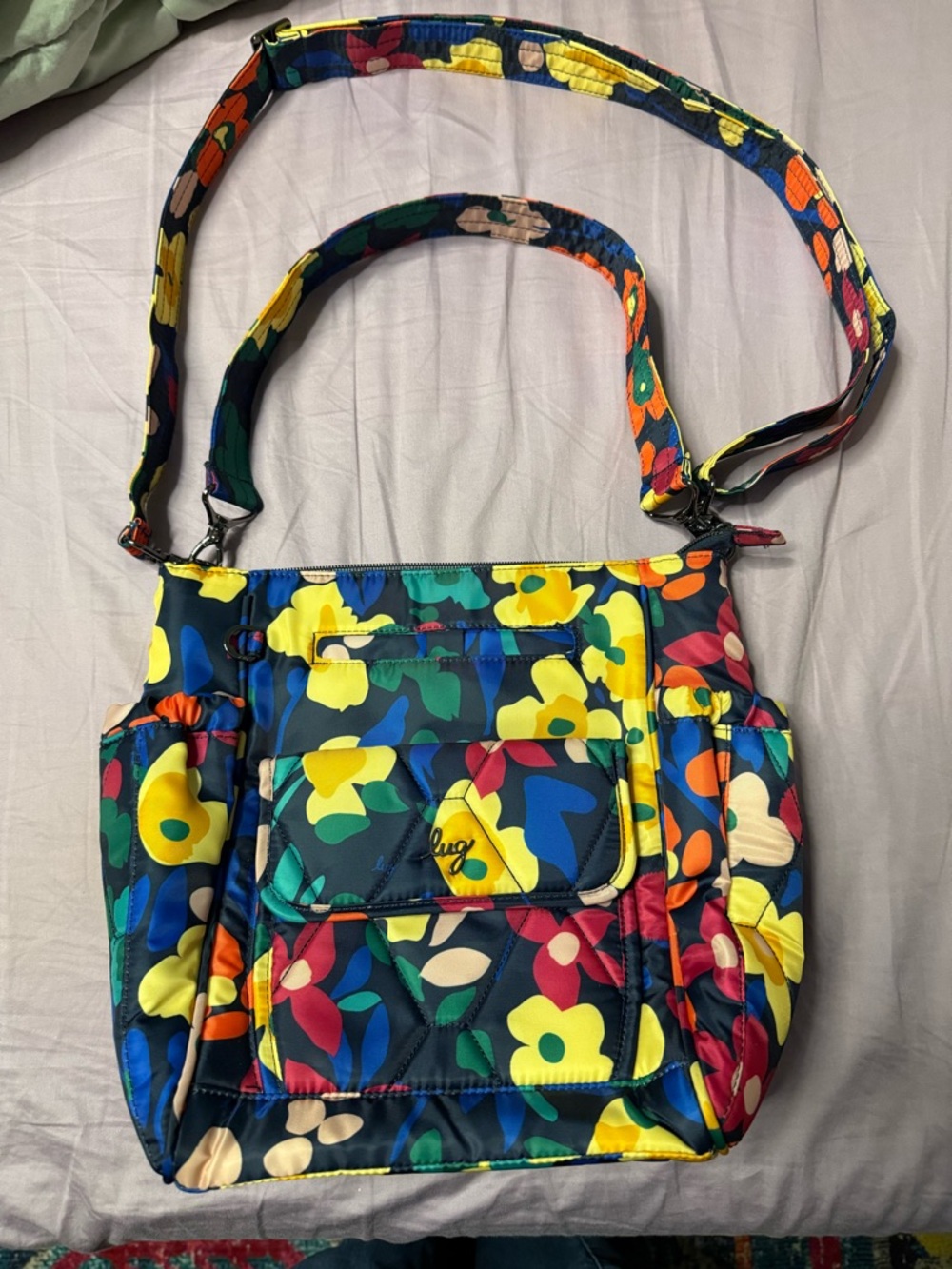Lug Toss with shoulder and crossbody strap. Navy wildflower